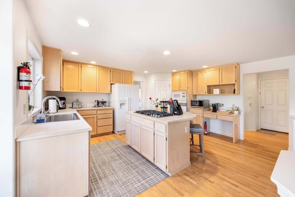 Featuring an open layout, ample cabinetry, and natural wood finishes, this kitchen is both stylish and functional for any home chef.