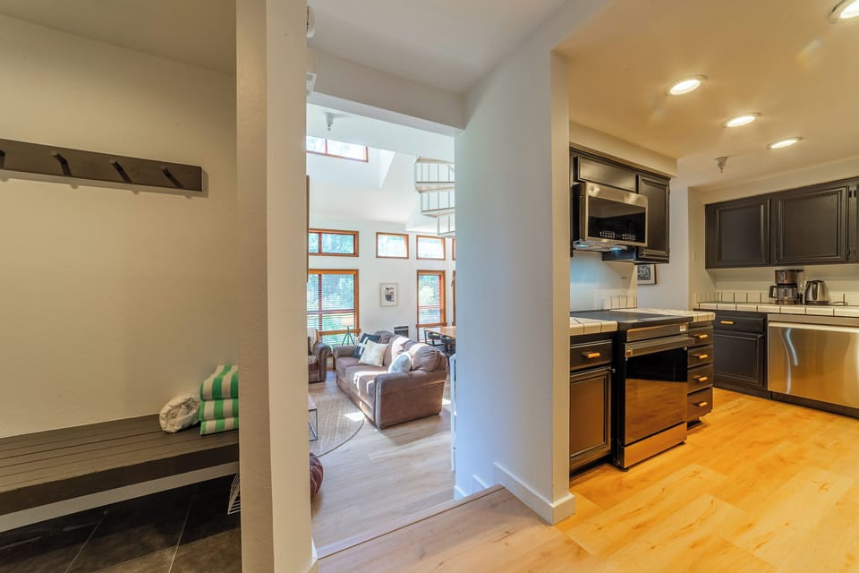 Open entryway to mudroom, kitchen, and living area.