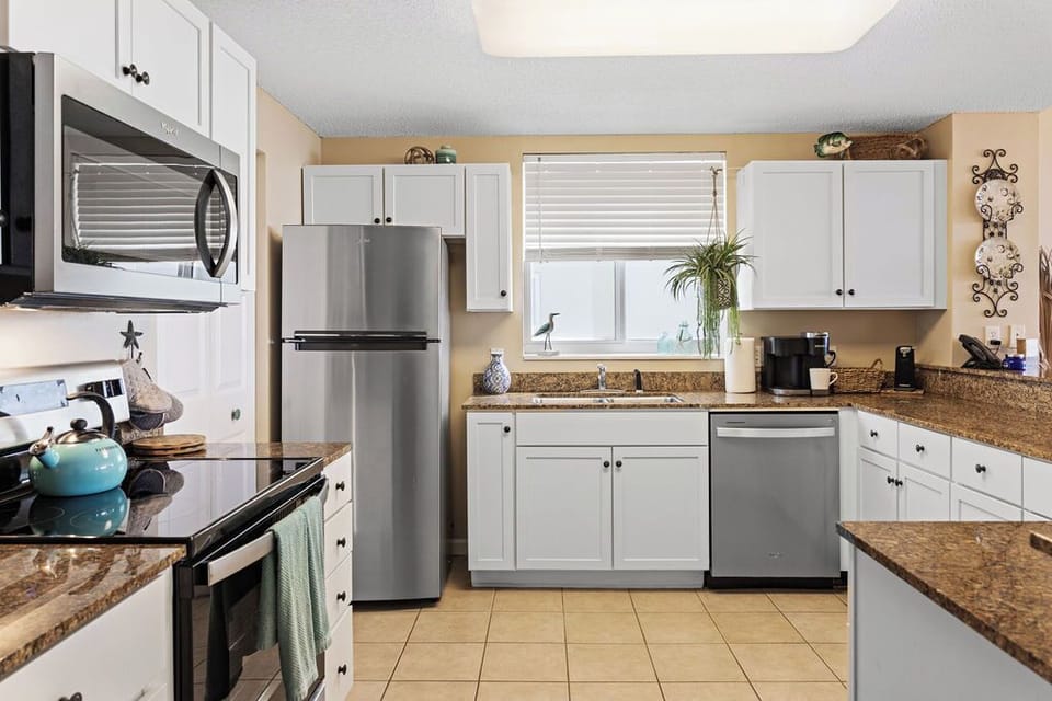 Kitchen - Preparing your meals during your stay is a breeze in this spacious, fully stocked kitchen.