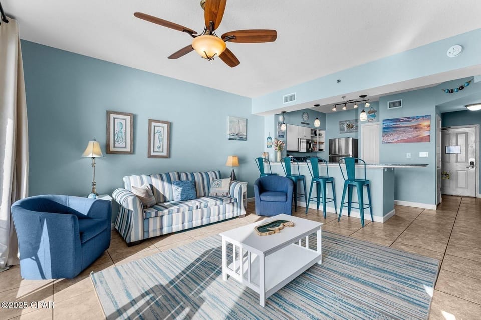 Open concept living area with balcony access and sleeper sofa