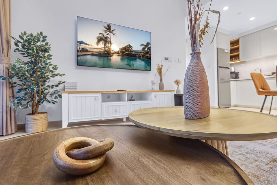 Living Room: Bright space featuring stylish decor, a view of the pool, and cozy gatherings await!