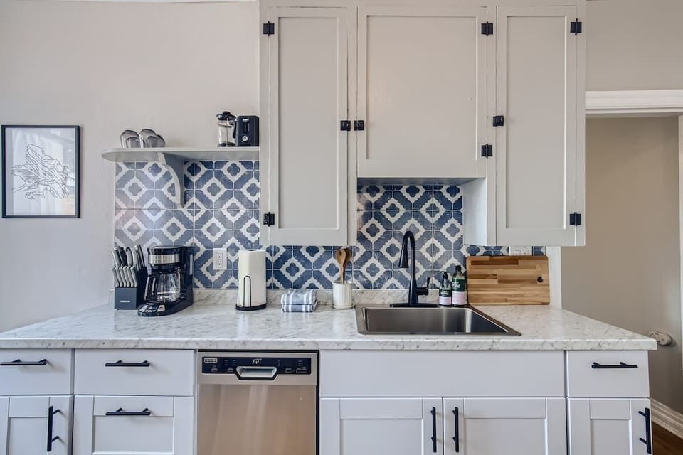 A beautiful white and blue kitchen stocked with all the essentials you need to prep food from home