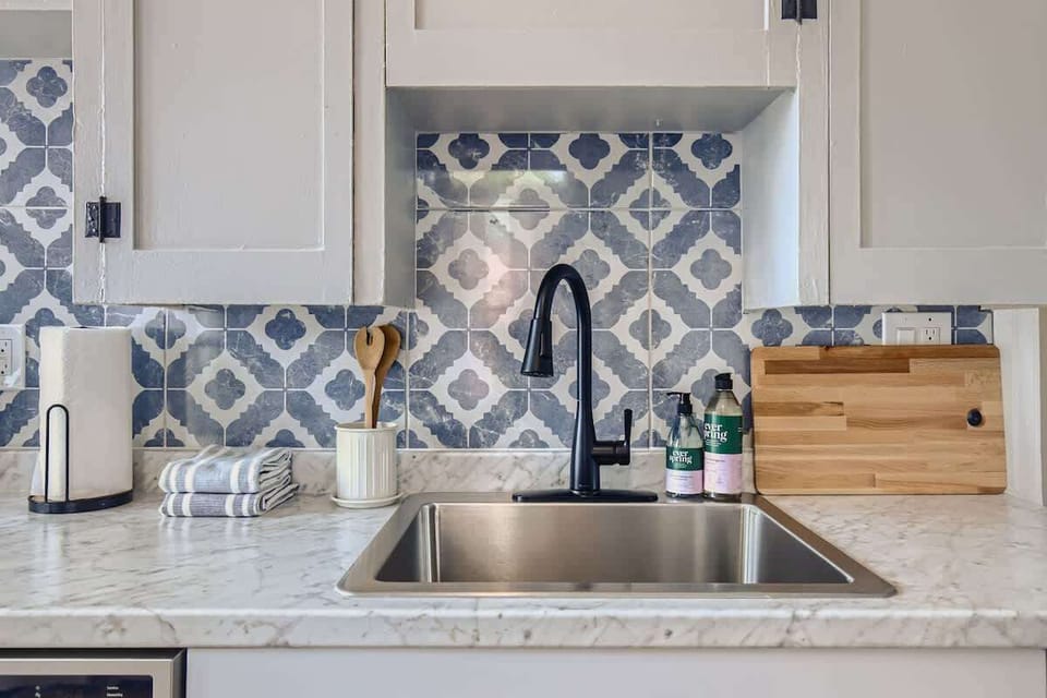 Marble counter tops and white cabinetry are just part of what makes this kitchen so great