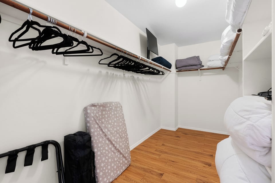well-equipped laundry room featuring hangers and plenty of space to keep your clothes fresh.