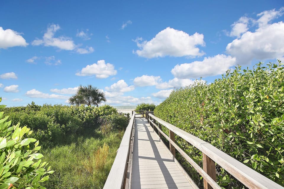 Boardwalk with ramp and stairs that lead to the beach.