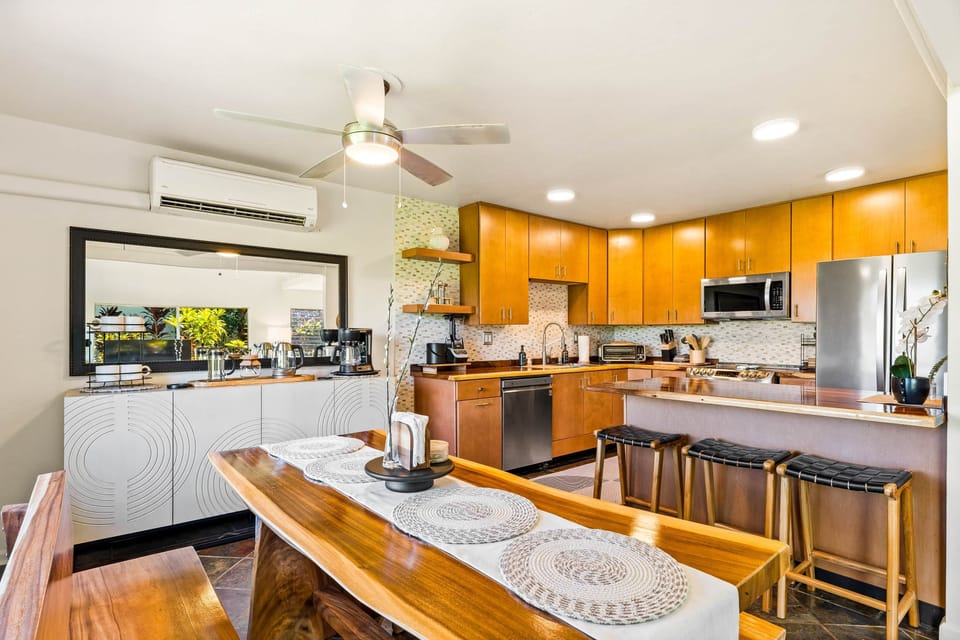 The warm wood tones and sleek appliances create the perfect backdrop for gatherings