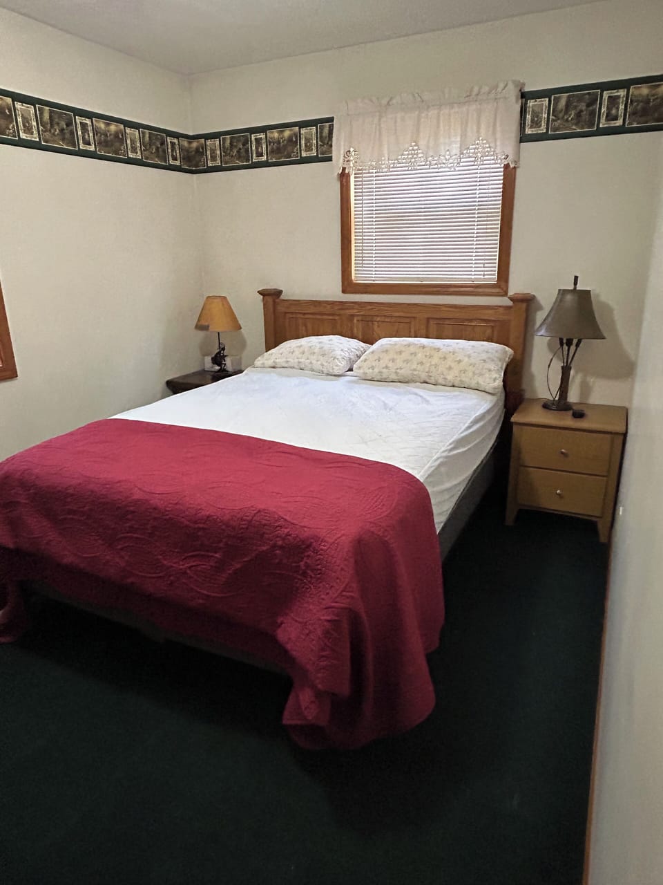 Queen size bed with dresser and closet. Side tables with lamps and extra outlets