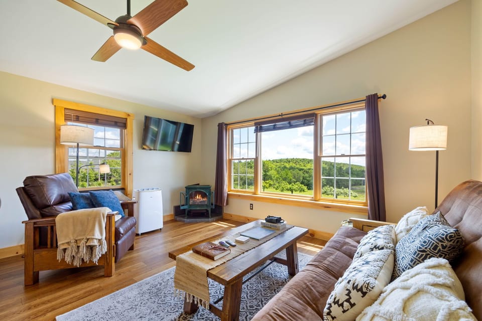 Living room with gas fireplace overlooking the farm.