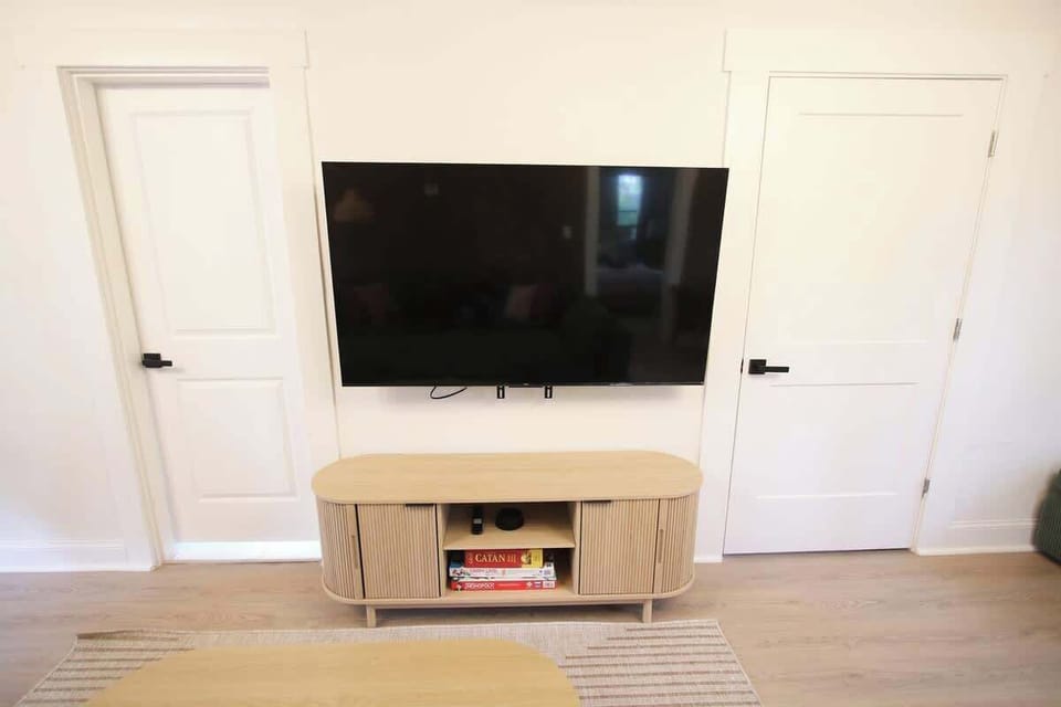 Watch your favorite Netflix show on our 65 inch Smart TV! You'll find lots of board games in the TV console here as well! 