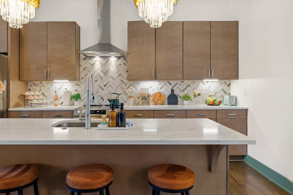 Indulge your baking passion in this luxurious kitchen! The expansive island makes it easy to roll out dough while the cozy bar seating invites friends to join in the fun.