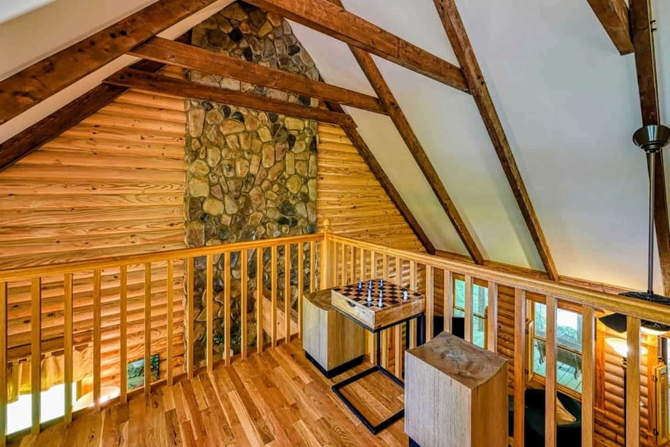 Challenge your friends to a game of chess or relax in this cozy loft space overlooking the warm, rustic interior of the cabin.