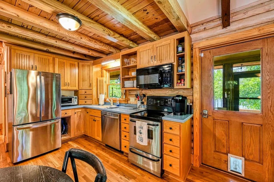 Enjoy the perfect blend of rustic charm and modern convenience in this fully equipped kitchen, ideal for preparing meals after a day of lakefront fun.
