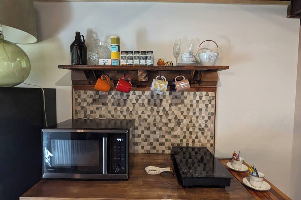 Stocked kitchenette with kinetic stove and a microwave / oven / air fryer