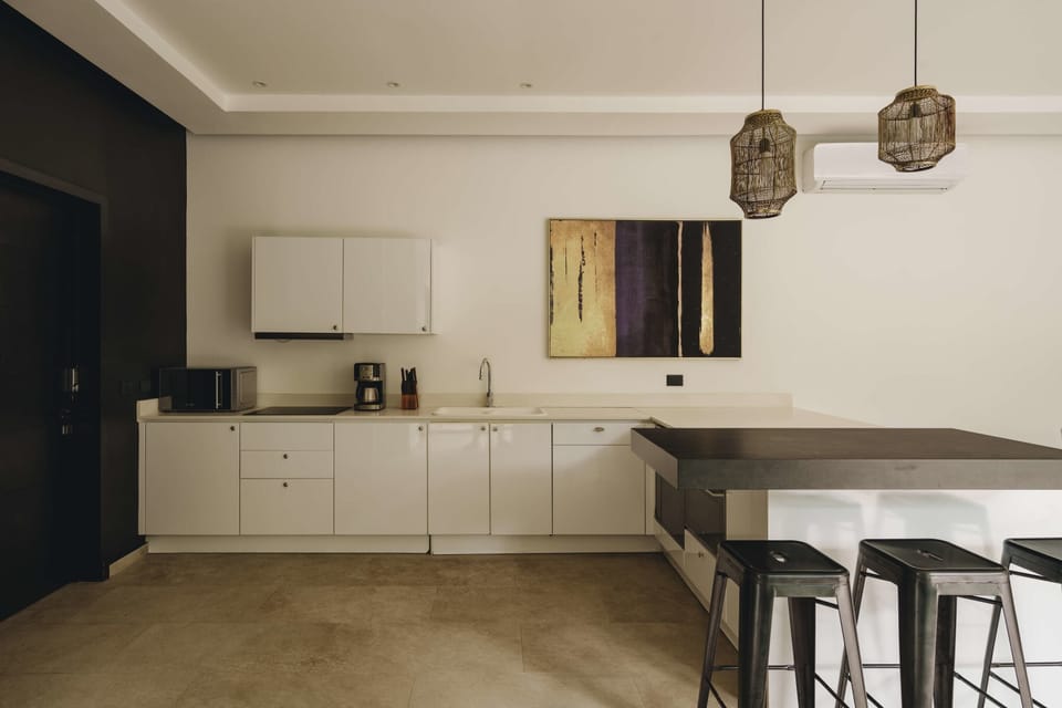 Modern fully equipped kitchen. It has a beautiful bar with seating for three people.