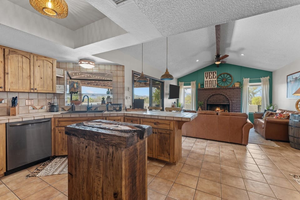 Modern and efficient—everything you need to create a delicious meal. The kitchen features a stainless steel refrigerator, stove, coffee maker, kitchenette oven, kettle, and blender.