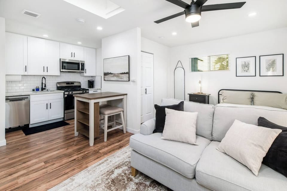 Bright open-concept living space with stylish kitchen &  cozy seating