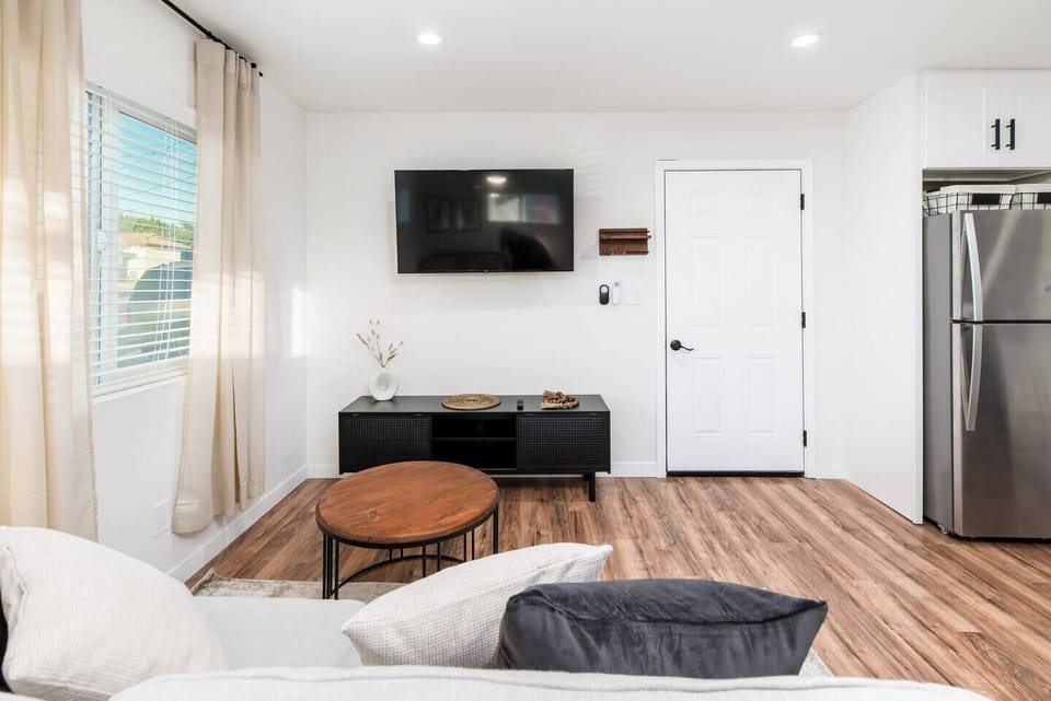 Inviting, modern living area featuring wood floors and natural light