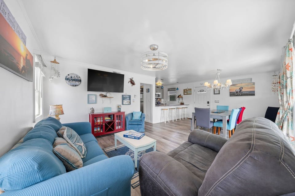 Living Room: Bright and airy space with beachy decor and modern amenities for ultimate relaxation!