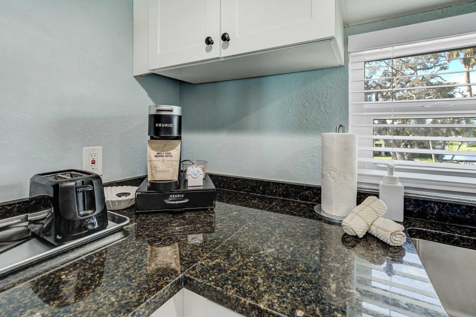 Start your day right with a fresh cup of coffee from the convenient coffee station, complete with a coffee maker, toaster, and kitchen essentials.





