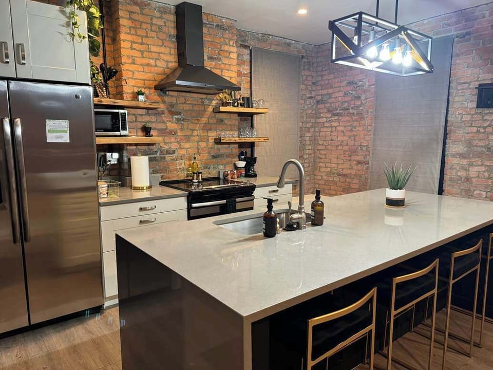 Discover culinary creativity in the kitchen at Russel Masterhouse. With ample counter space and high-end finishes, this Columbus Airbnb is built for delicious adventures! 