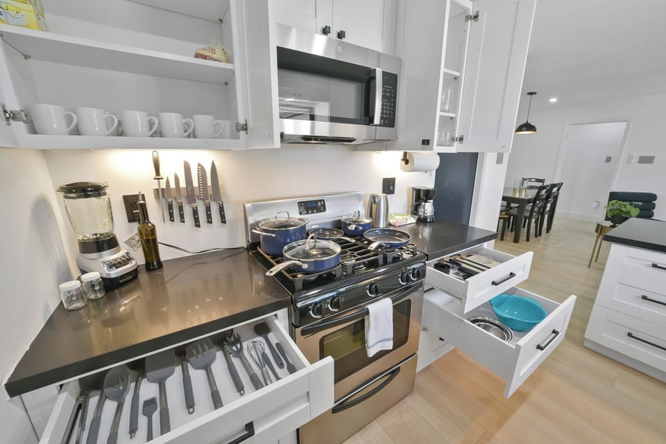 Fully equipped kitchen with modern appliances, cookware, and utensils, ready for any culinary need.
