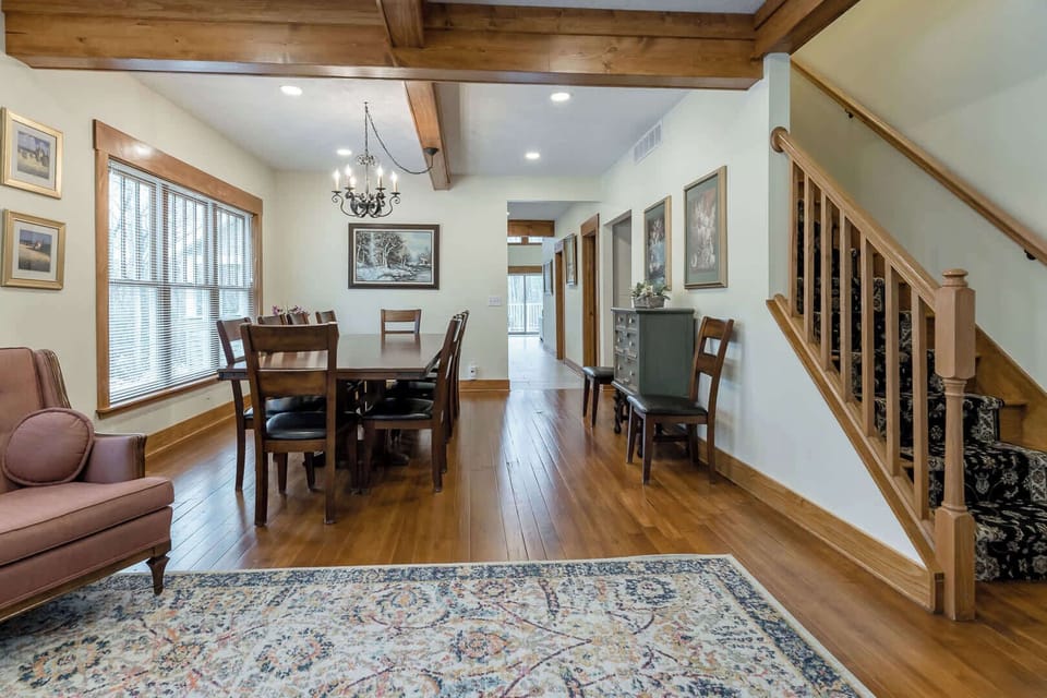 North-facing view of the Scott Creek Lodge dining room with stairs to the right leading up to 4 of the 7 bedrooms & 4 of the 7.5 bathrooms