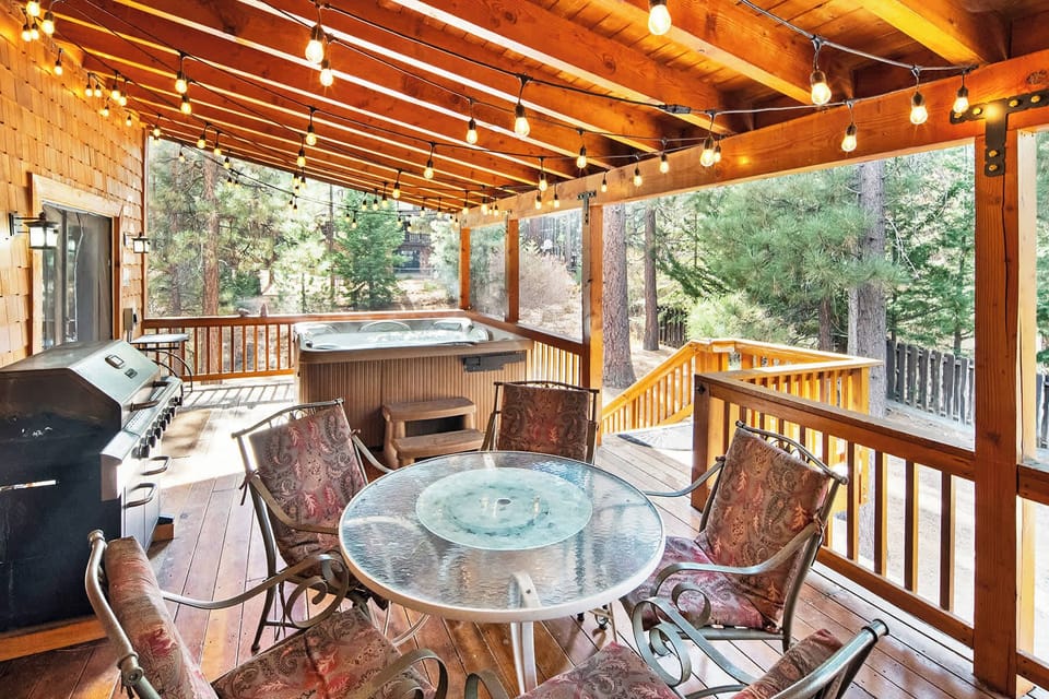 Huge covered outside deck. Featuring a gas bbq, relaxing hot tub and seating area for dining al fresco