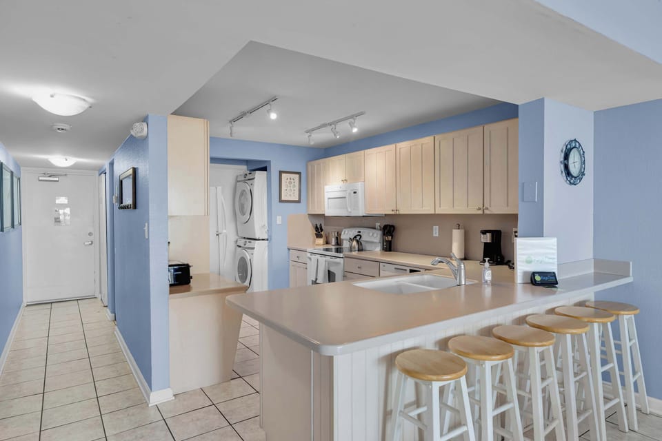 Fully stocked Kitchen with Water View; Dishwasher, Stove/Oven, Microwave; K-Cup and Drip Coffee Makers; Full Size Washer & Dryer In-Unit; Bar Seating; 