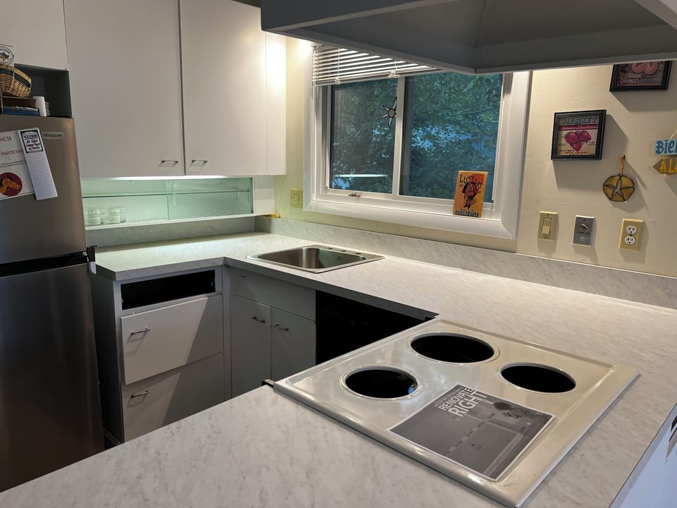 Newly renovated kitchen fully stocked with essentials and dishwasher, microwave
