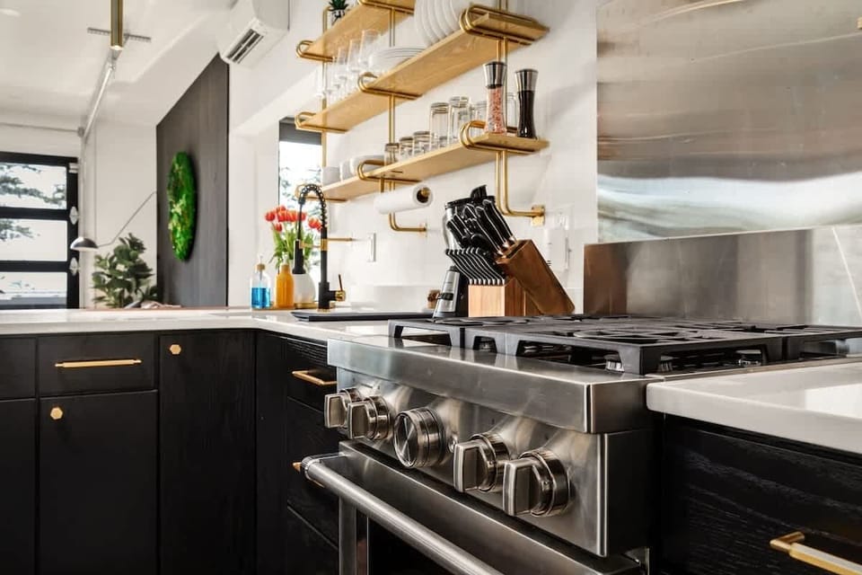 Well stocked kitchen, custom angled sink. 4 burner gas stove and electric oven.