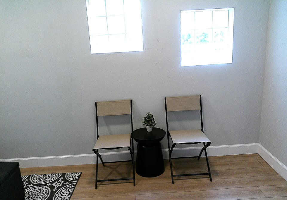 Porch chairs and table in front entry way