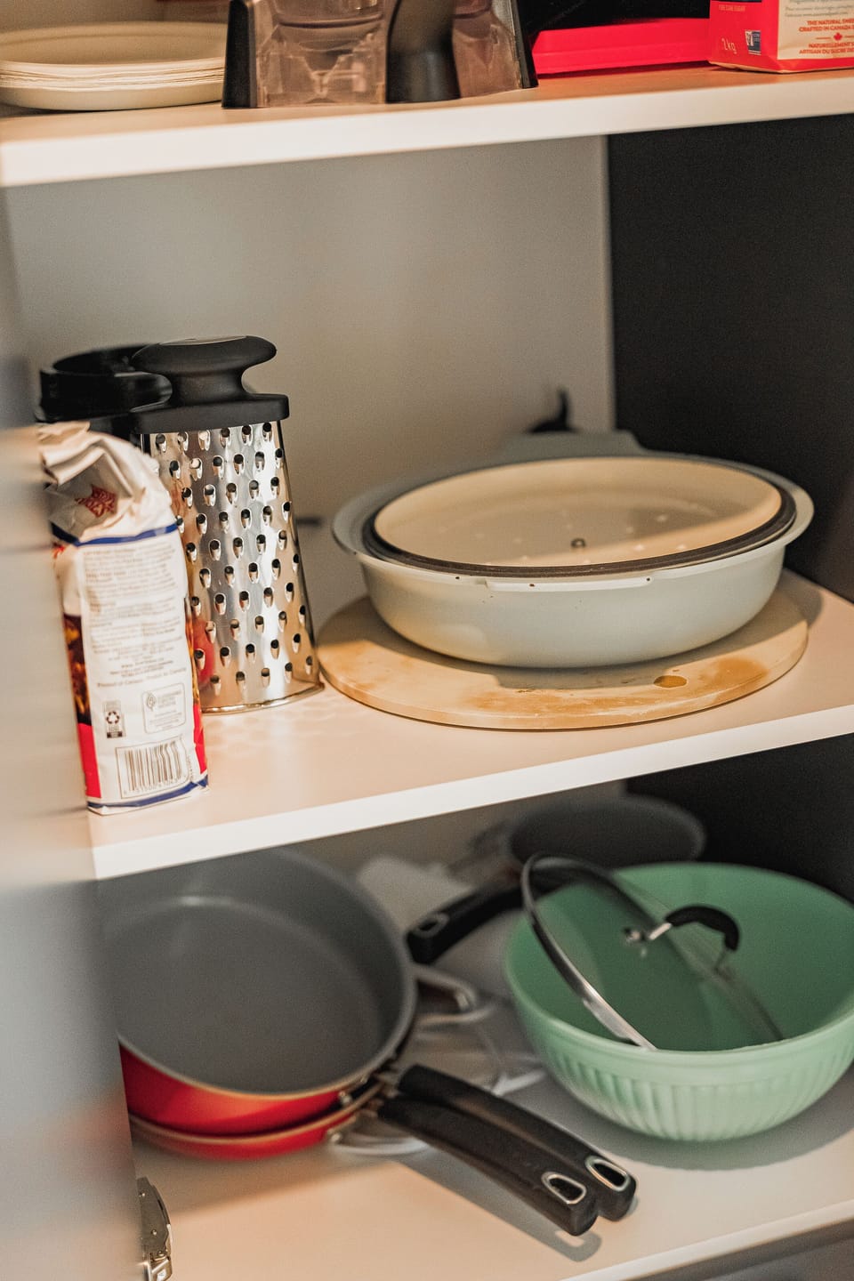 Organized kitchen essentials including pan set and food prep tools.