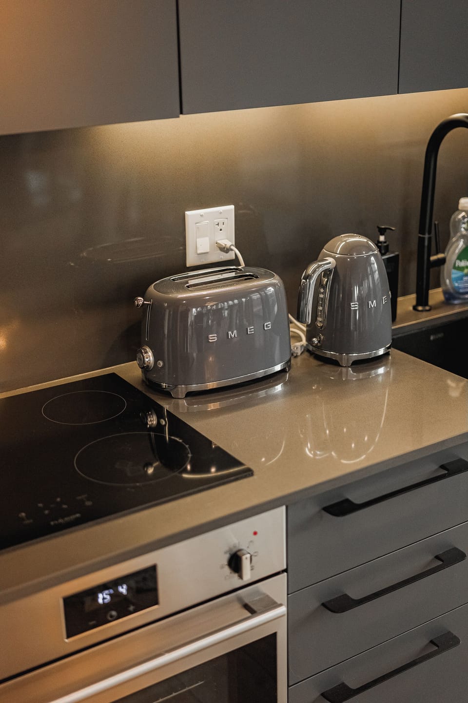 Limited edition SMEG Toasters and Kettle on sleek black countertop
