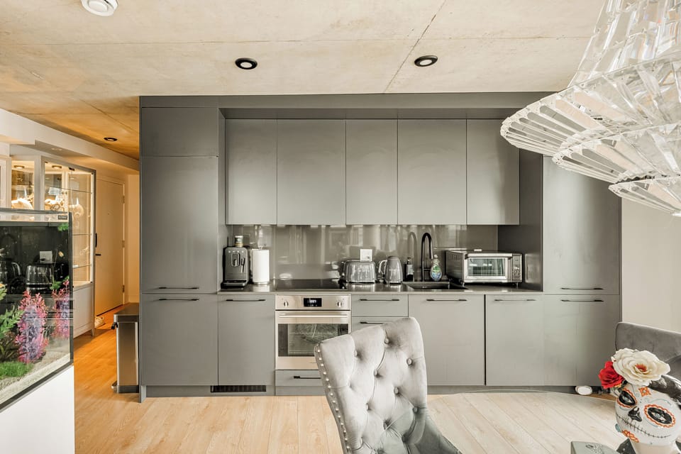 Contemporary kitchen with built-in appliances and minimalist finishes.