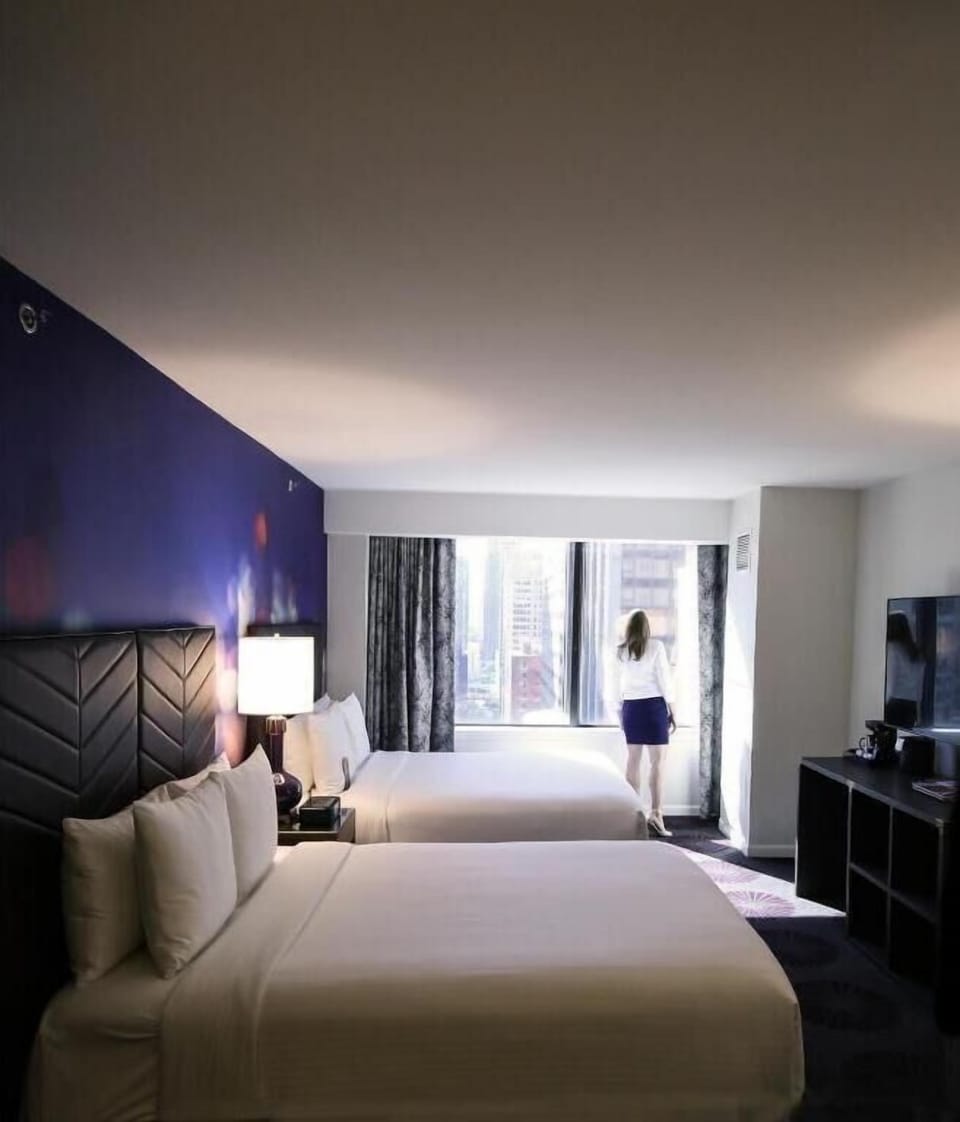 Wake up to city light spilling through the wide window.