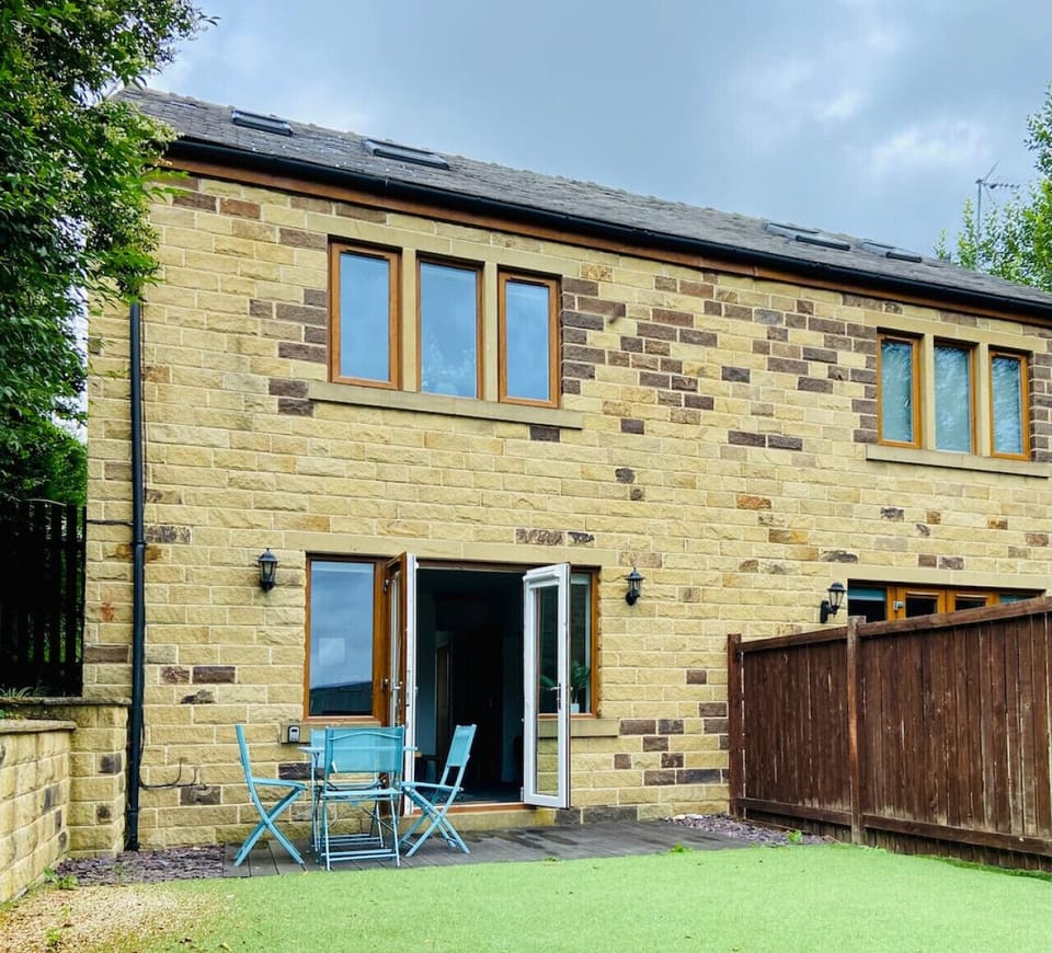 Private fenced rear garden with patio access