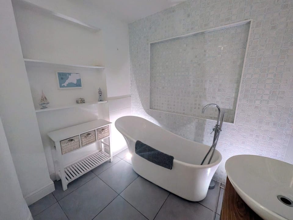 Main bathroom with colour-changing lights for a relaxing soak.