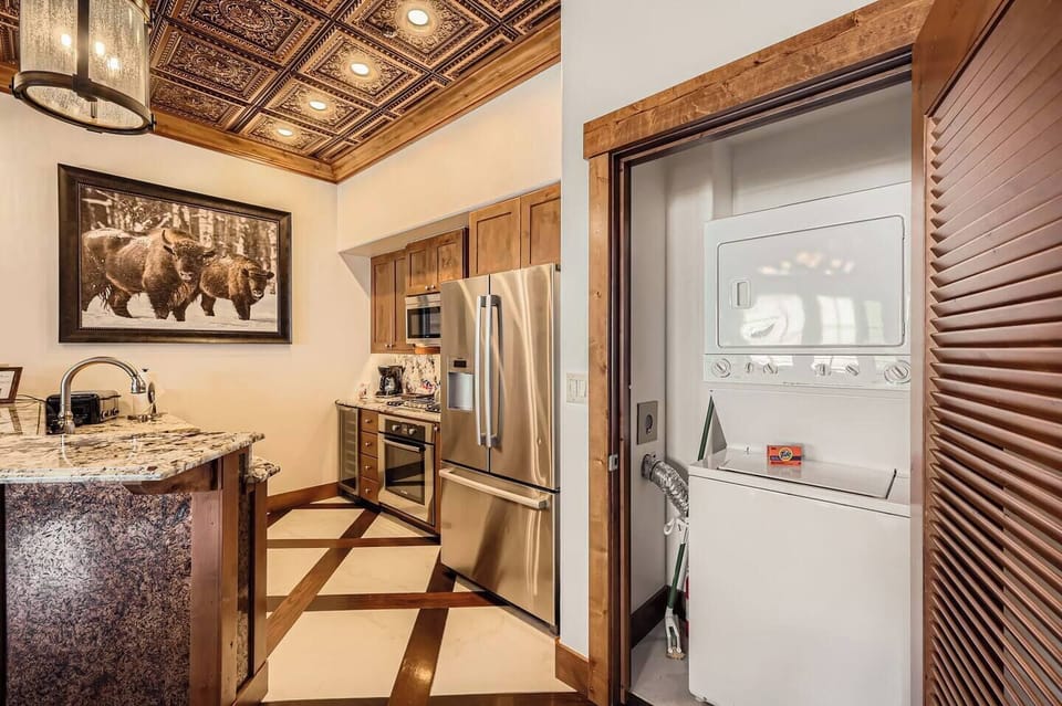 Stainless appliances, granite counters, and rich wood cabinetry.