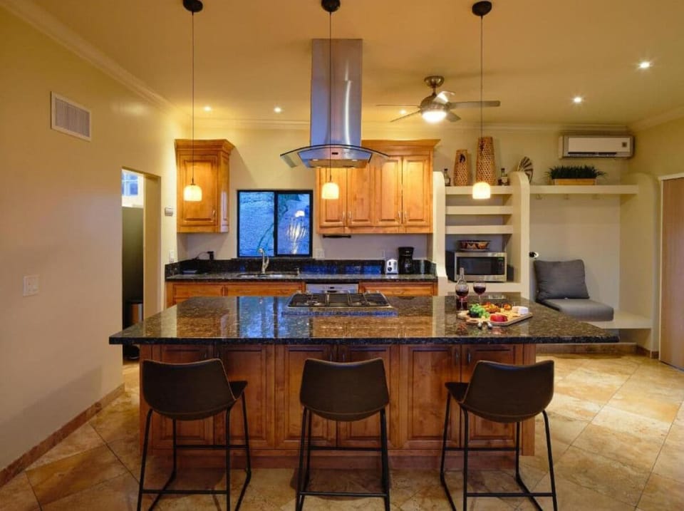 Sip a drink at this 9 foot granite slab while the chef cooks your favorite meal.
