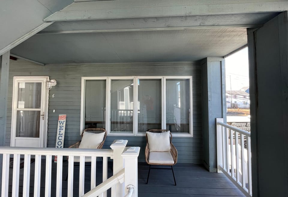 Second level entry with outdoor seating to catch a shore breeze.