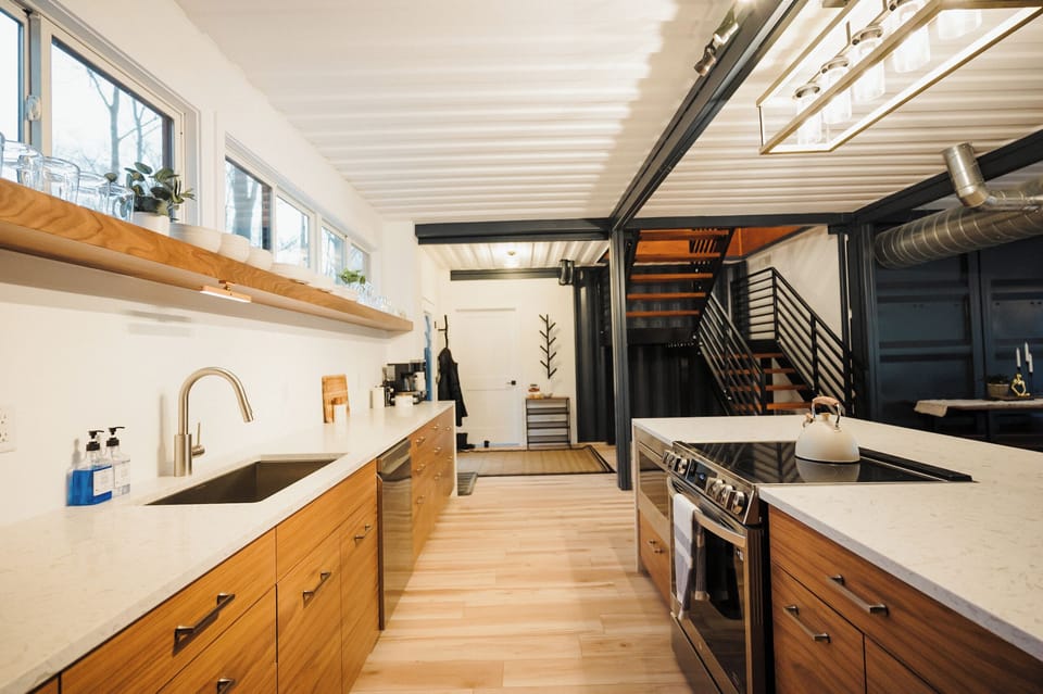 Views of the kitchen and stairs that lead to the upstairs bedroom