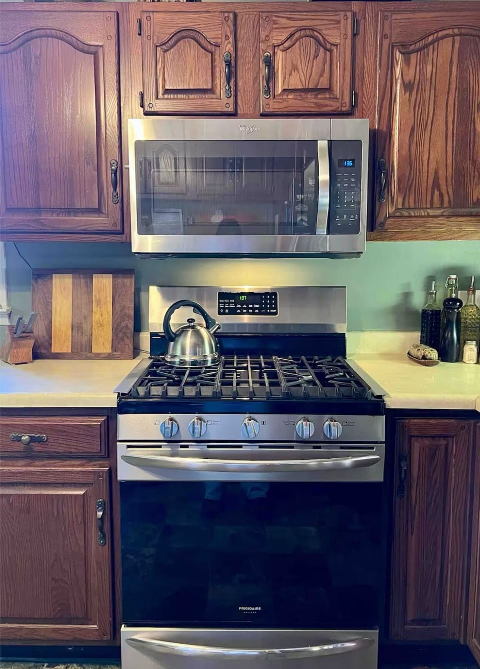 Propane range and oven, microwave, and fully loaded kitchen.