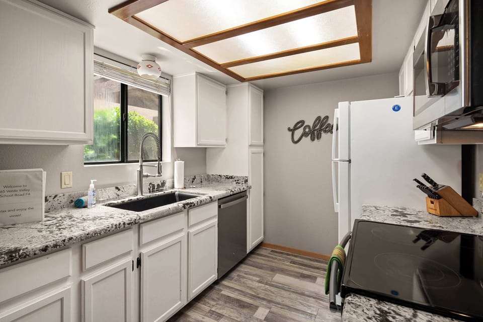 Fully equipped kitchen with stainless appliances and ample space for easy home cooking.