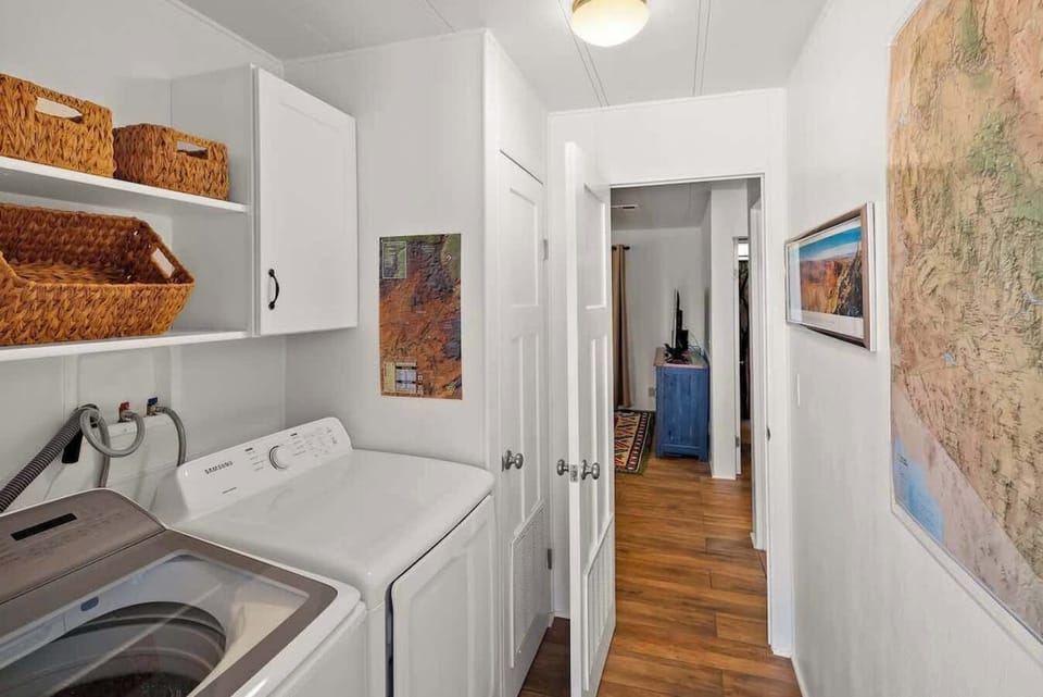 Convenient in-unit laundry area with washer, dryer, and storage.