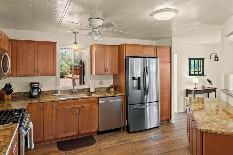 Modern kitchen featuring granite counters and stainless steel appliances.
