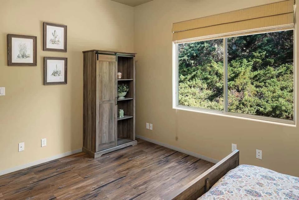 Wake up to beautiful views from this bright and inviting bedroom.