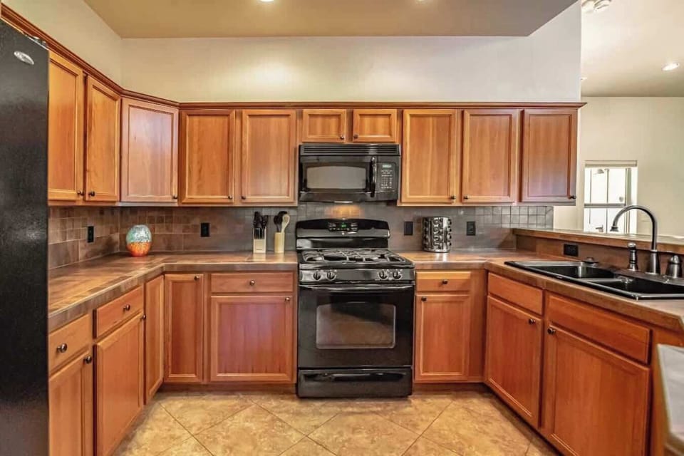 Fully loaded kitchen stocked with dish soap, detergent, sponge, paper towels and trash bags.