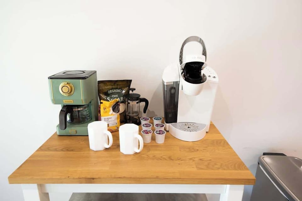 Start your morning right at this fully stocked coffee station featuring drip and pod coffee makers, mugs, and supplies.