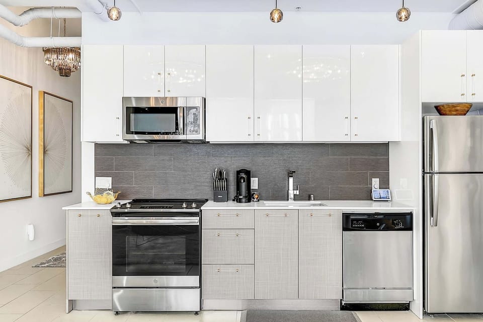 Fully-equipped and stocked kitchen with stainless steel appliances, cutlery, toaster, blender, kettle, french press, and a Keurig.