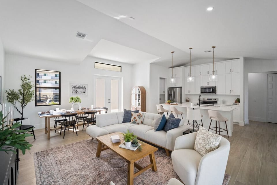 Spacious and bright living area with comfy seating and a coastal vibe